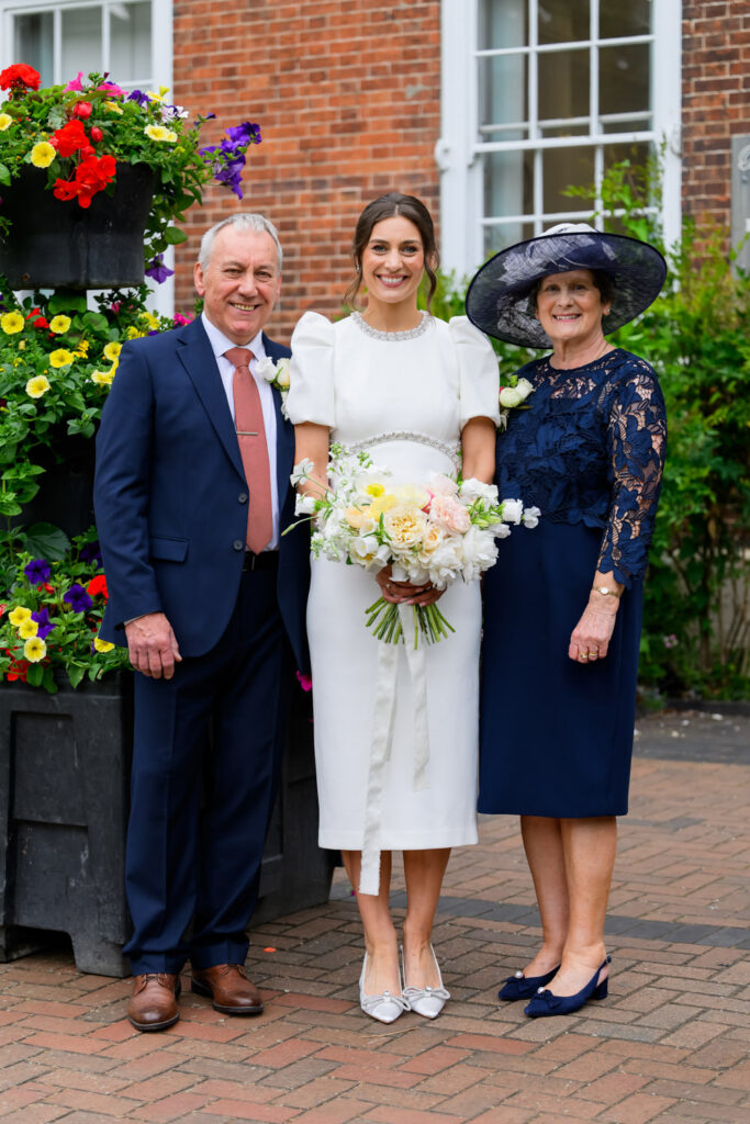 Bride with her parents outside West Bridgford Registry Office after the ceremony