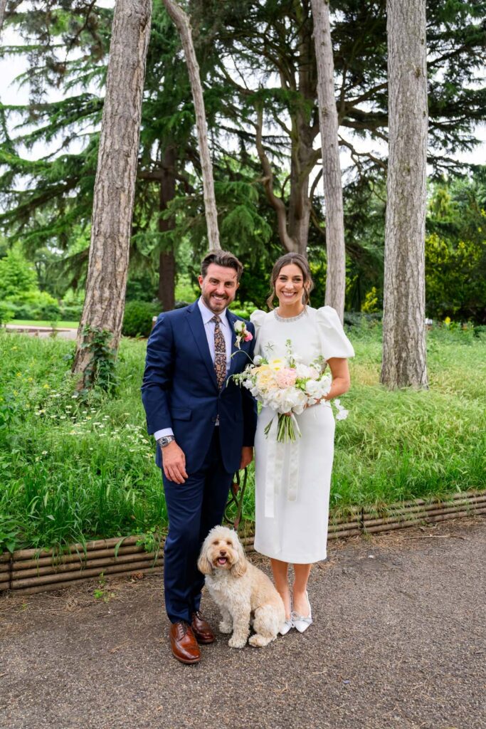 Bride and groom with their dog during wedding portraits in West Bridgford Park