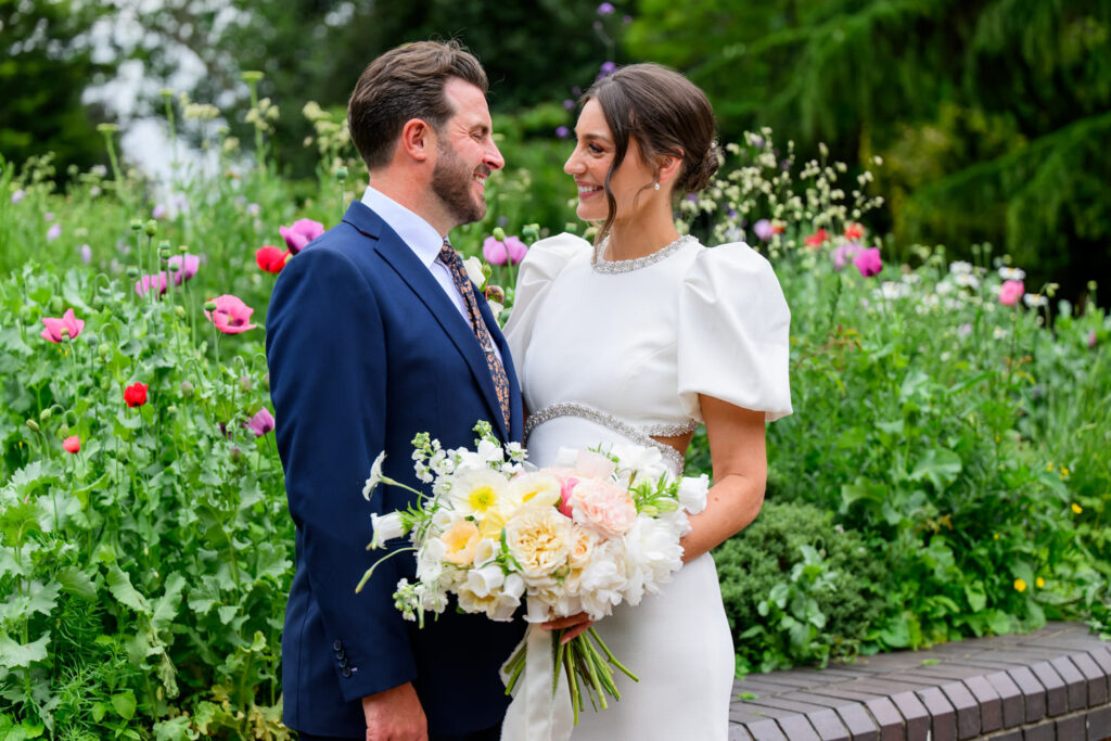 Bride and groom portrait with summer flowers in West Bridgford Park
