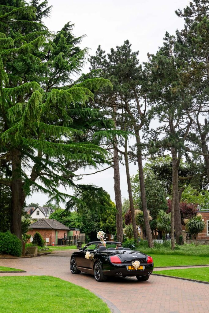 Wedding car driving through West Bridgford Park after the ceremony