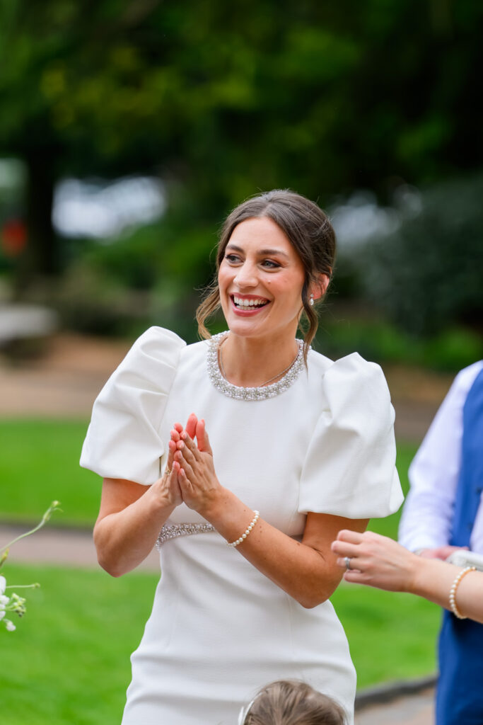 Bride smiling with guests outside West Bridgford Registry Office before the ceremony