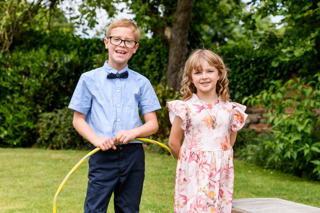 Children smiling during garden reception at Allington Manor wedding in Lincolnshire