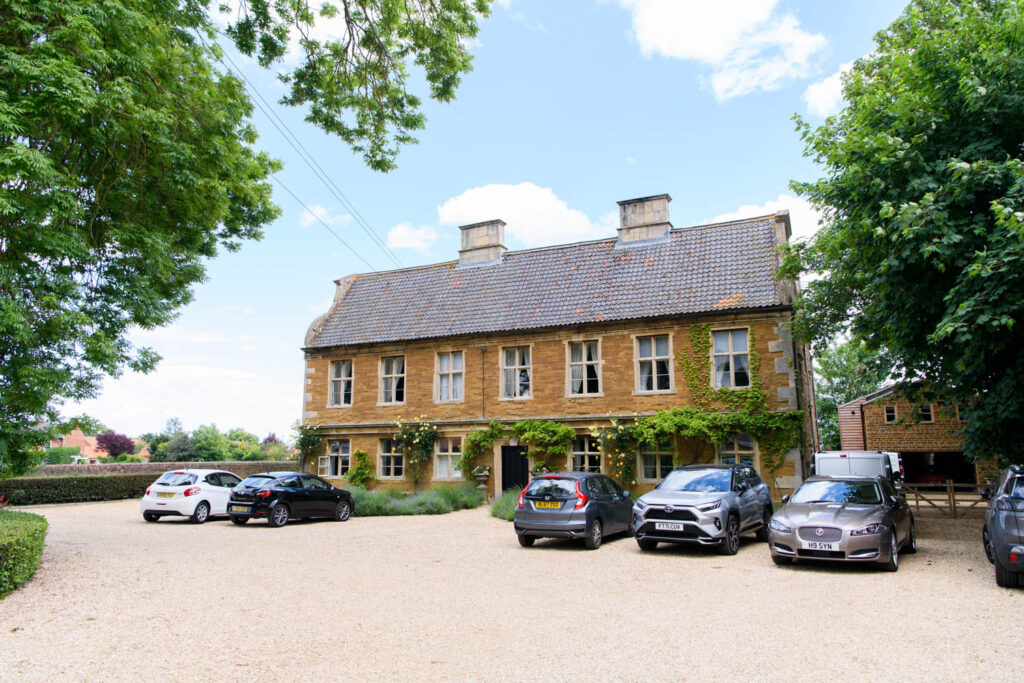 Front view of Allington Manor wedding venue in Lincolnshire with historic stone house and courtyard