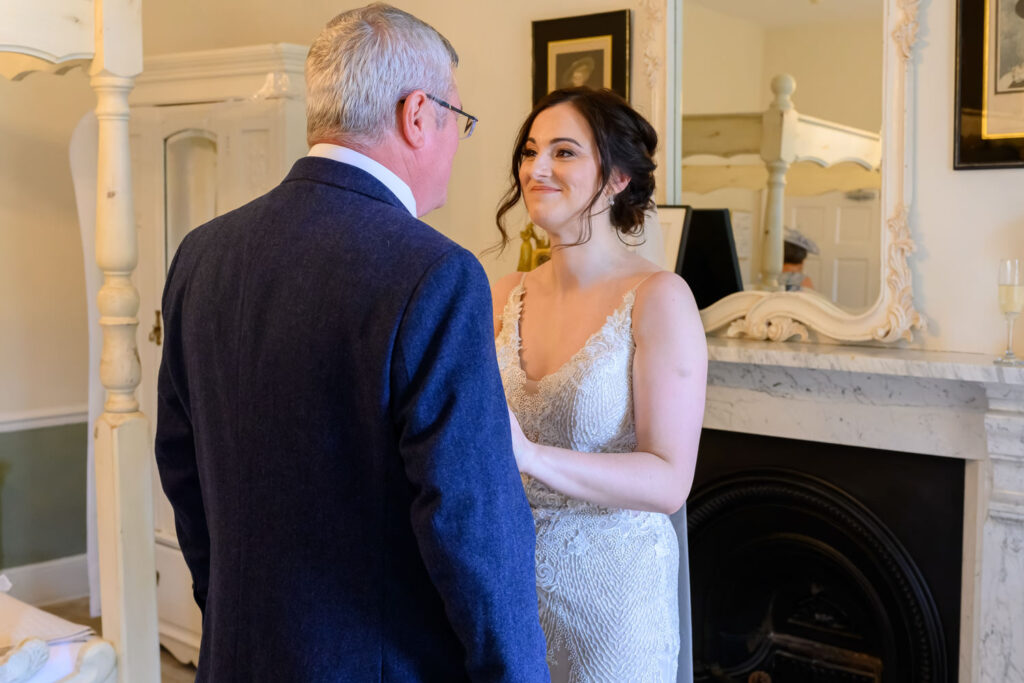 Bride sharing a special moment with her father during morning preparations at Allington Manor