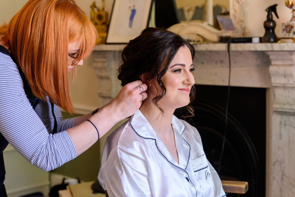 Bride having her hair styled during morning preparations at Allington Manor wedding venue in Lincolnshire