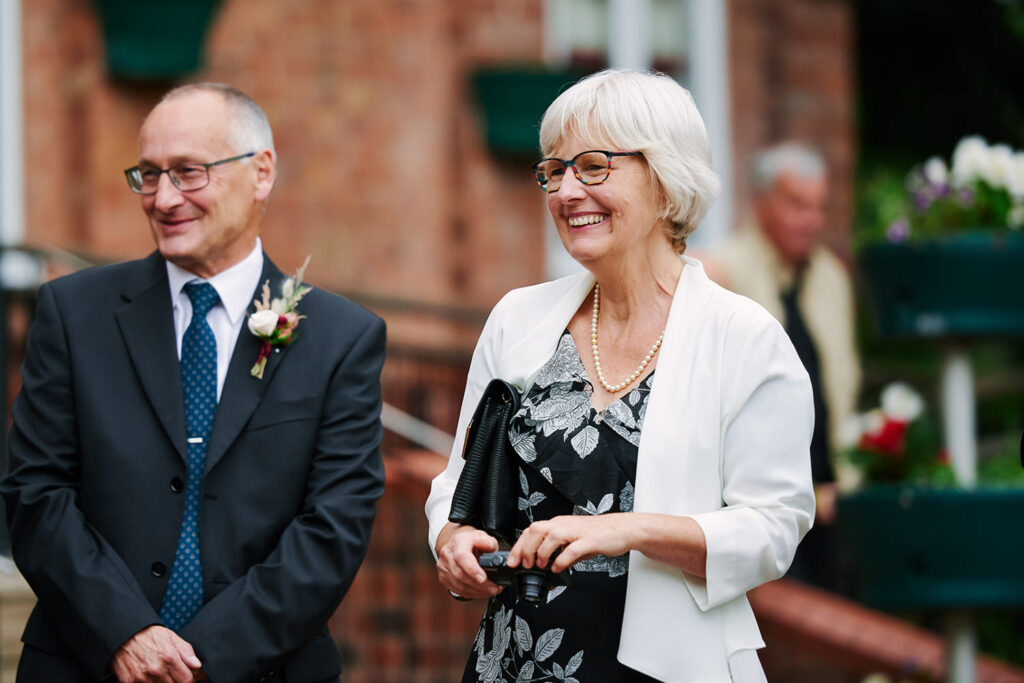 Guest smiling outside a Nottingham registry office wedding