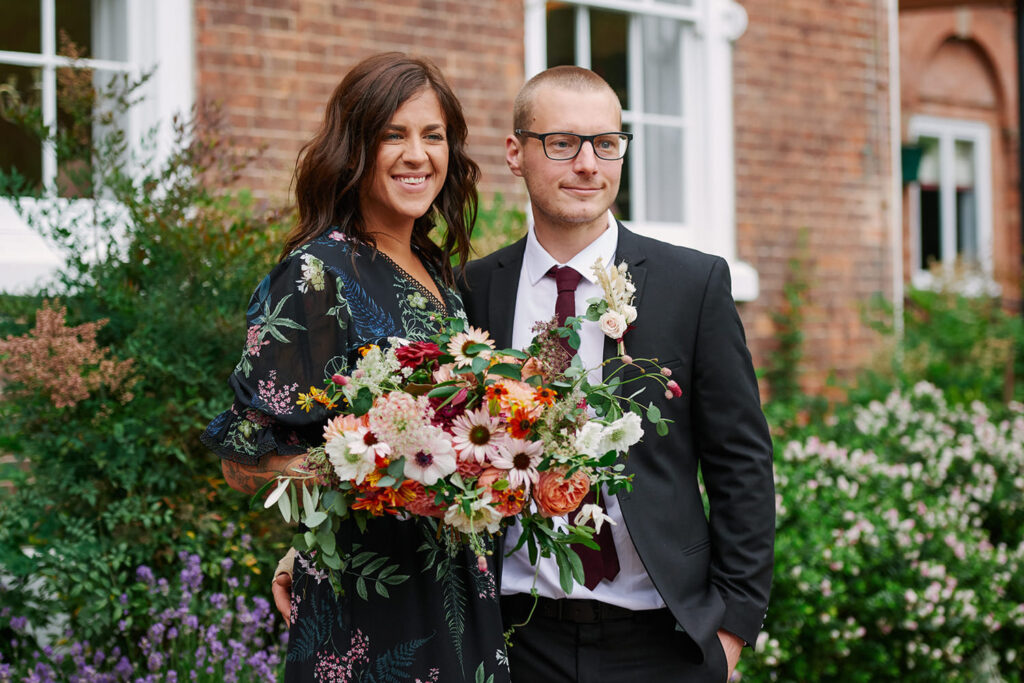 Bride and groom portrait with colourful bouquet during an alternative Nottingham wedding