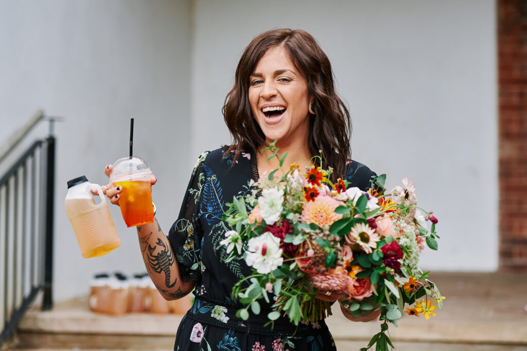Bride holding cocktails during relaxed celebrations after a Nottingham wedding ceremony