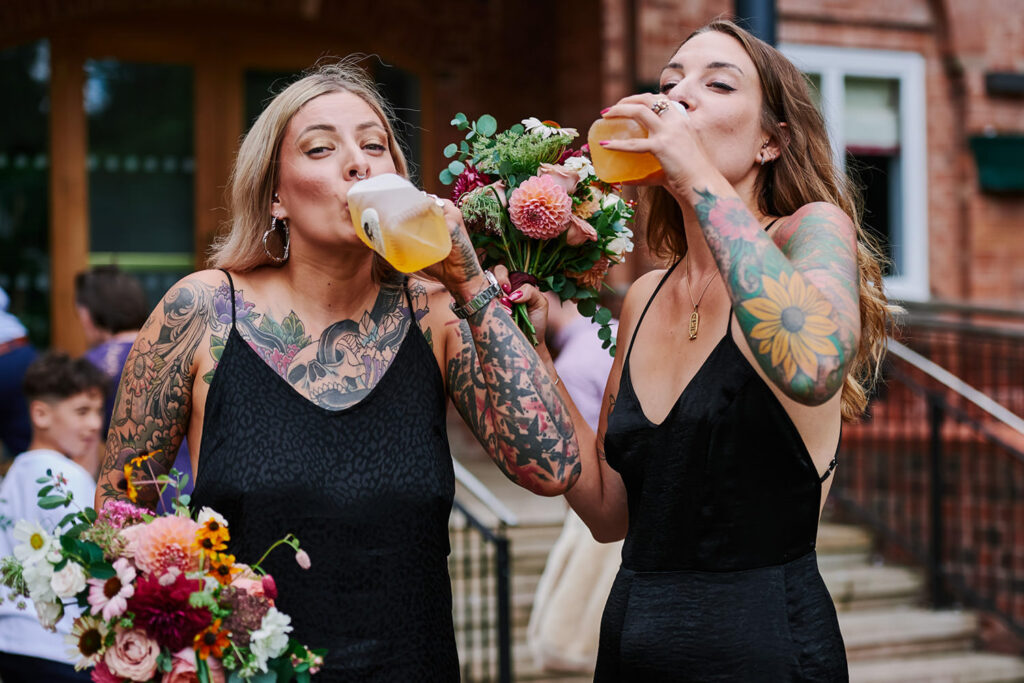 Tattooed bridesmaids drinking cocktails after a registry office wedding in Nottingham