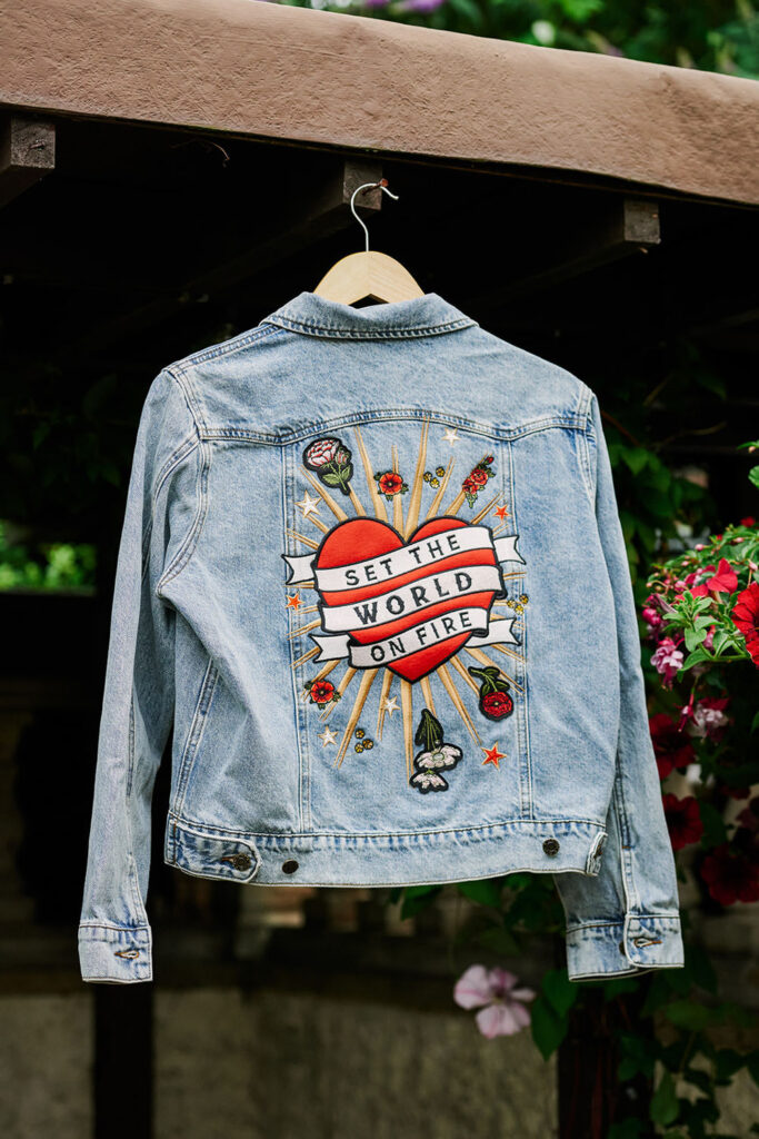 Custom denim wedding jacket with “Set the World on Fire” embroidery