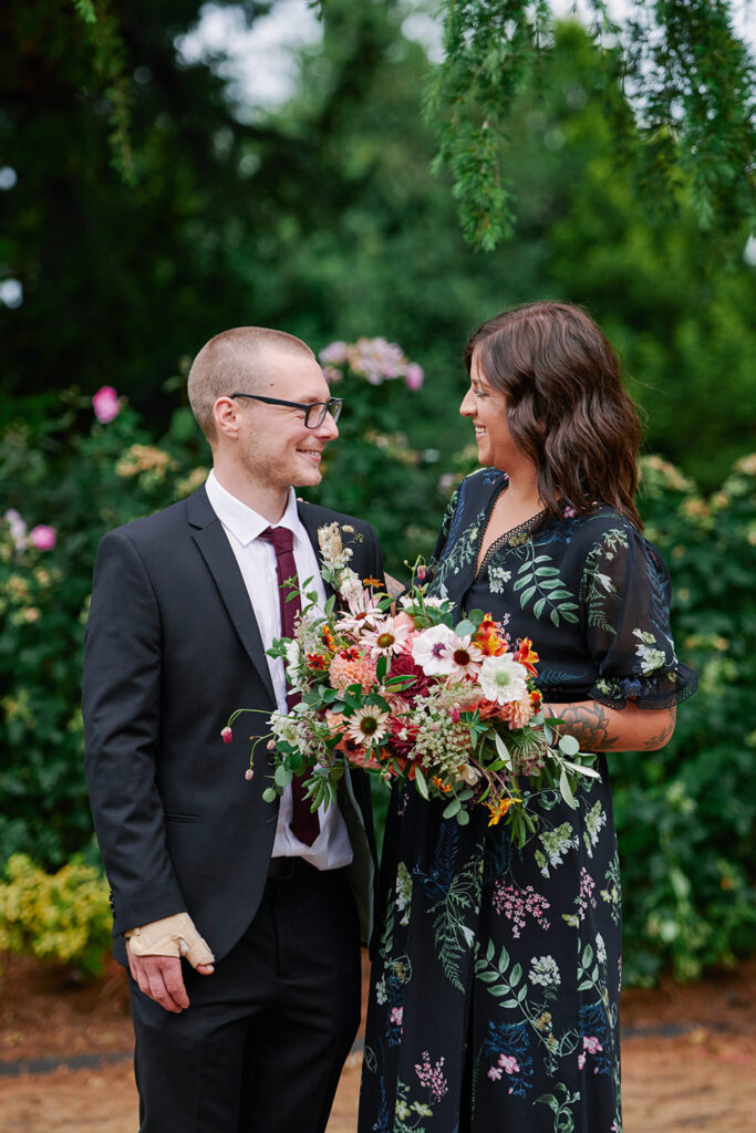 Alternative bride and groom laughing during relaxed wedding portraits in Nottingham