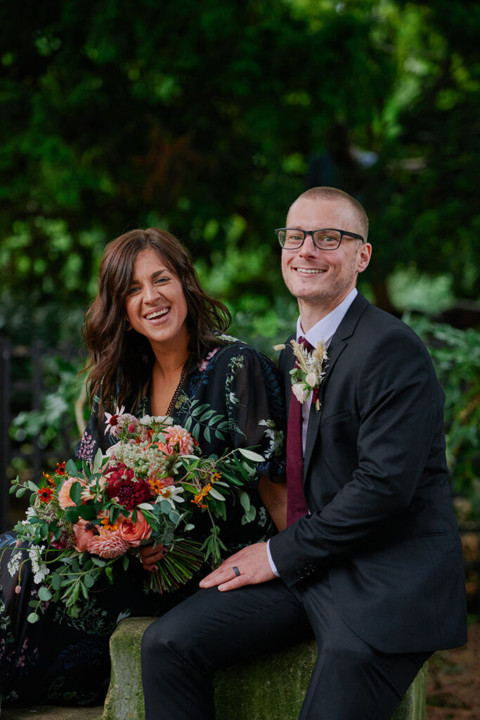 Bride and groom sitting together during relaxed Nottingham wedding portraits