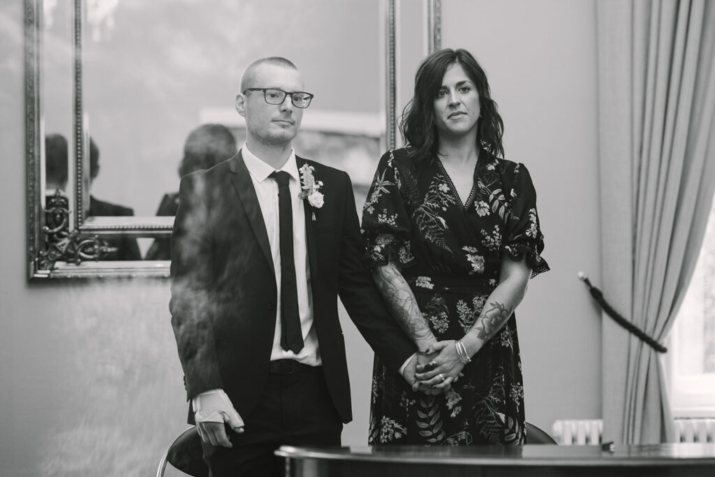 Couple standing together during a small registry office wedding ceremony