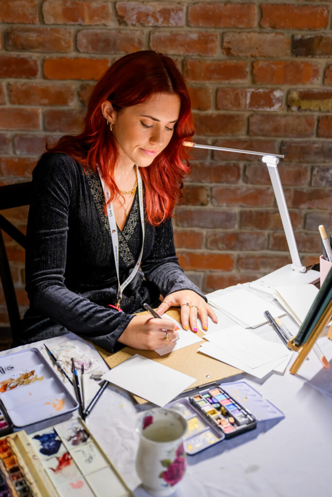 Live wedding illustrator creating guest portrait during reception