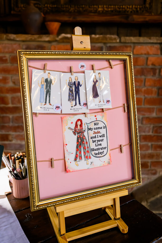 Framed wedding illustration display showing couple artwork at barn wedding reception