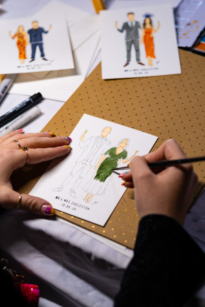 Wedding guest illustration being painted during reception entertainment