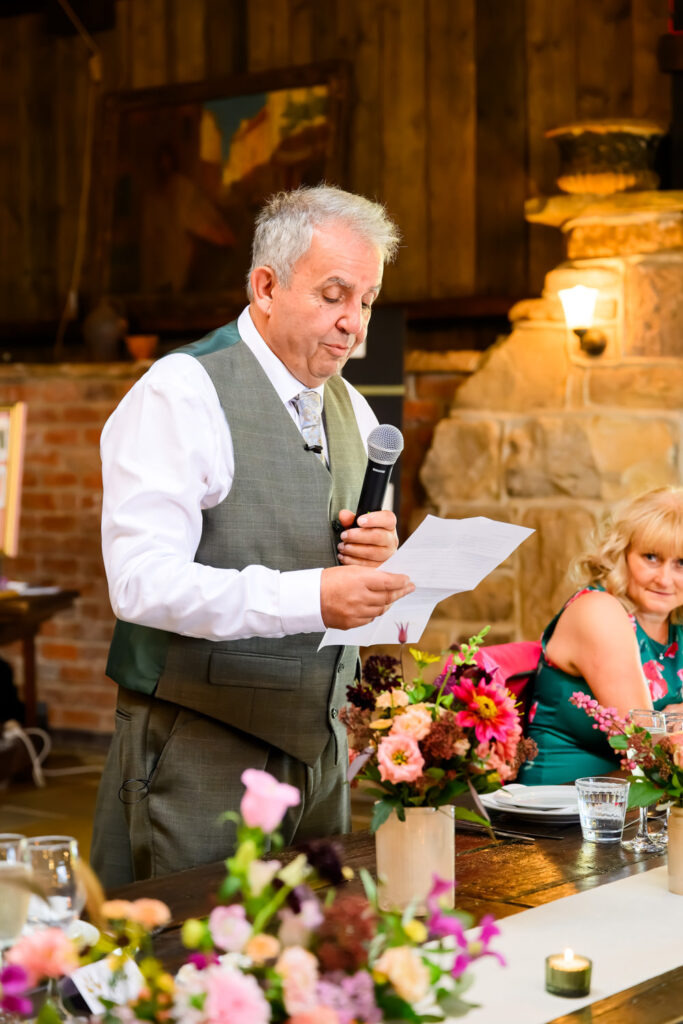 Father of the bride giving emotional wedding speech during reception