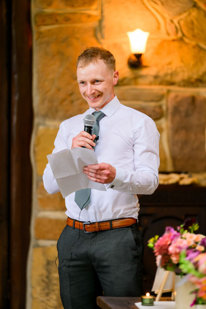 Best man delivering speech during wedding reception