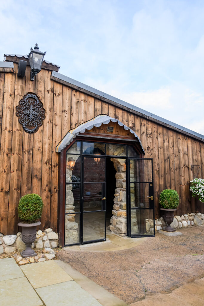 Entrance to the rustic barn ceremony space at Willow Marsh Farm wedding venue