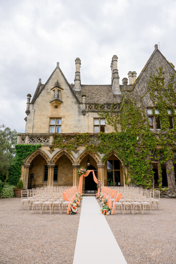 Outdoor ceremony setup with floral arrangements at Manor by the Lake wedding venue.