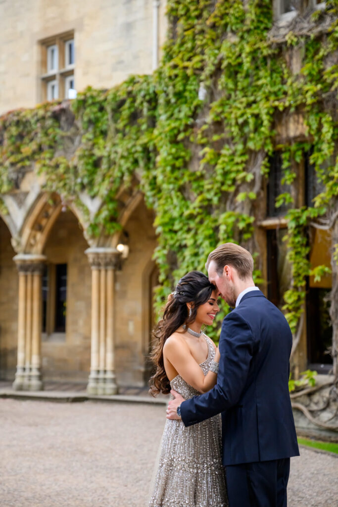 Romantic Manor by the Lake wedding photography of the couple embracing in the courtyard.
