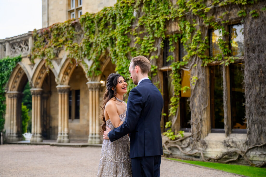 Romantic wedding portrait of the bride and groom in front of the ivy-covered arches at Manor by the Lake.