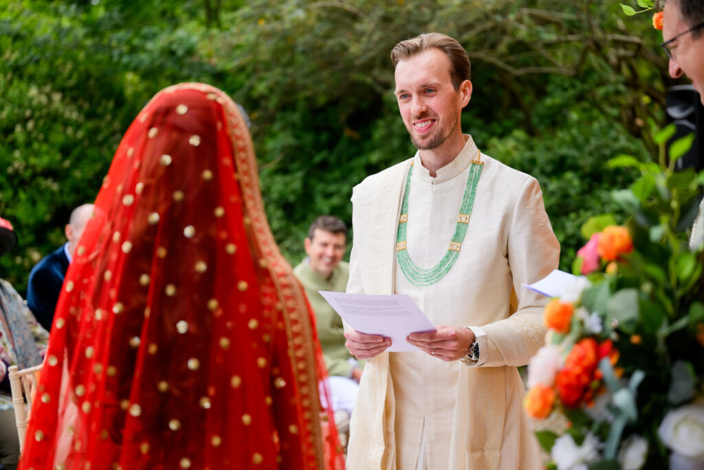 Groom reading his vows during the wedding ceremony at Manor by the Lake.