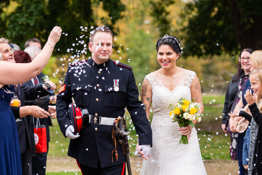 bride & groom walking through confetti at Colwick Hall in Nottingham