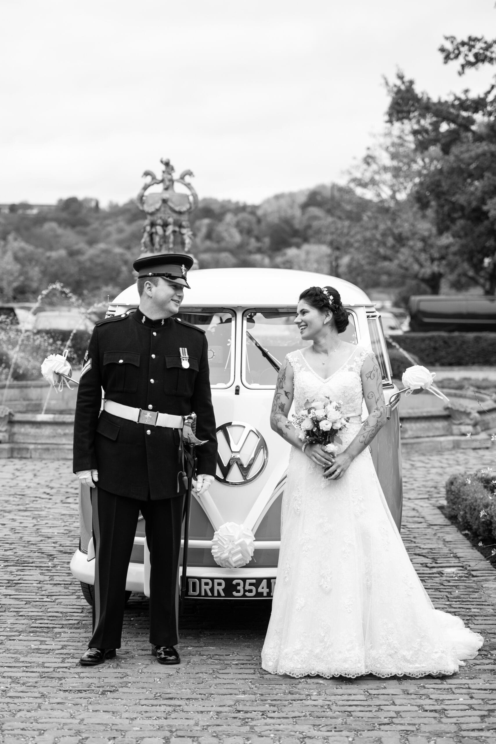 wedding couple smiling in front of vw campervan at Colwick Hall