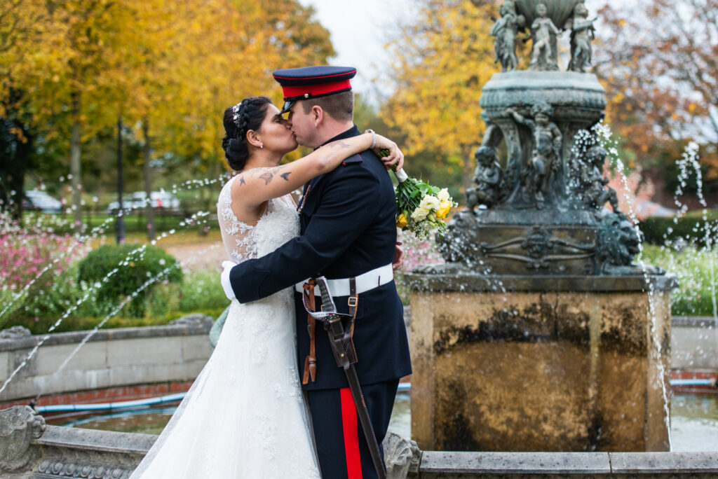 Bride & groom kissing in front of the fountain at Colwick Hall wedding venue