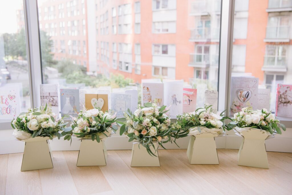 flower bouquets lined up in front of window