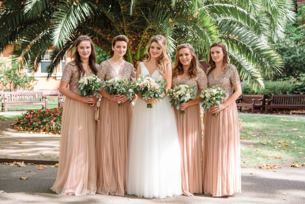 bride with her bridesmaids in mount street gardens during summer wedding in Mayfair