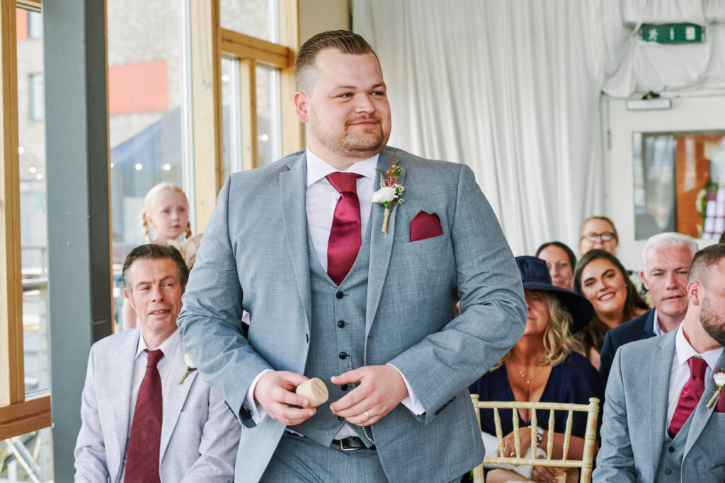 Best man holding ring box during wedding ceremony in the river rooms