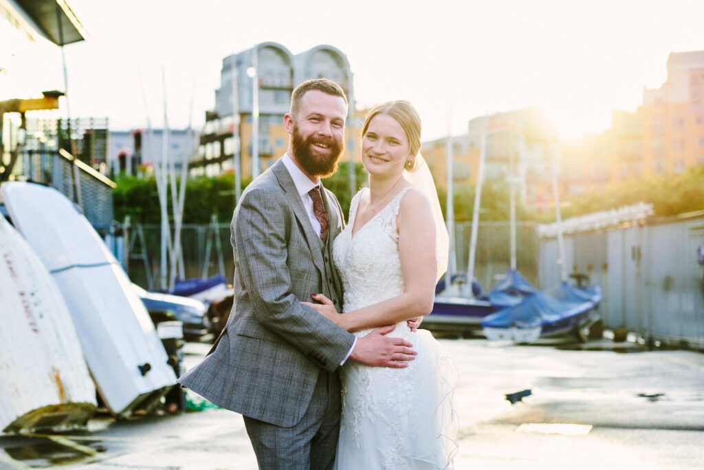 Wedding couple smiling during sunset in the boat yard at Greenwich Yacht Club