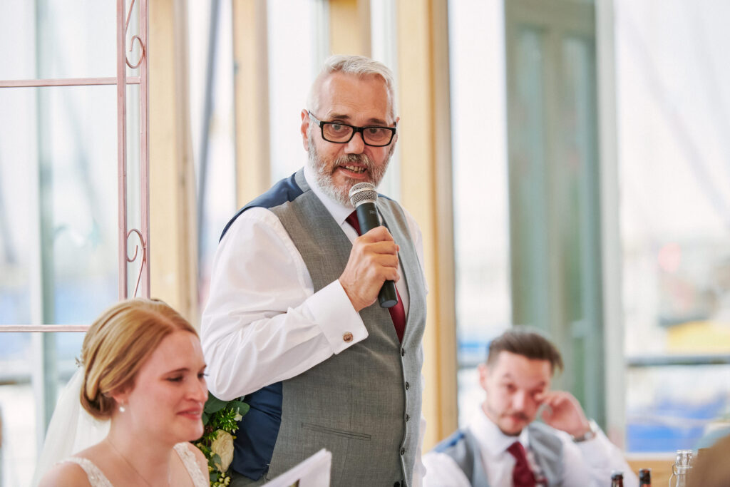 Father of the bride giving a speech in the main hall at Greenwich Yacht Club
