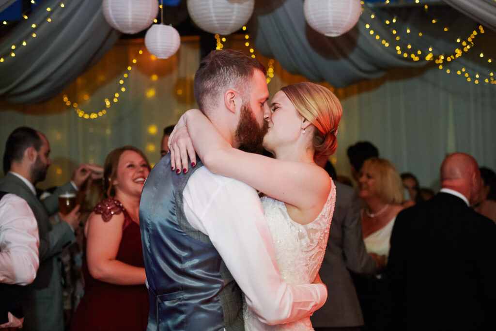 Bride and groom kissing during their first dance at Greenwich Yacht Club