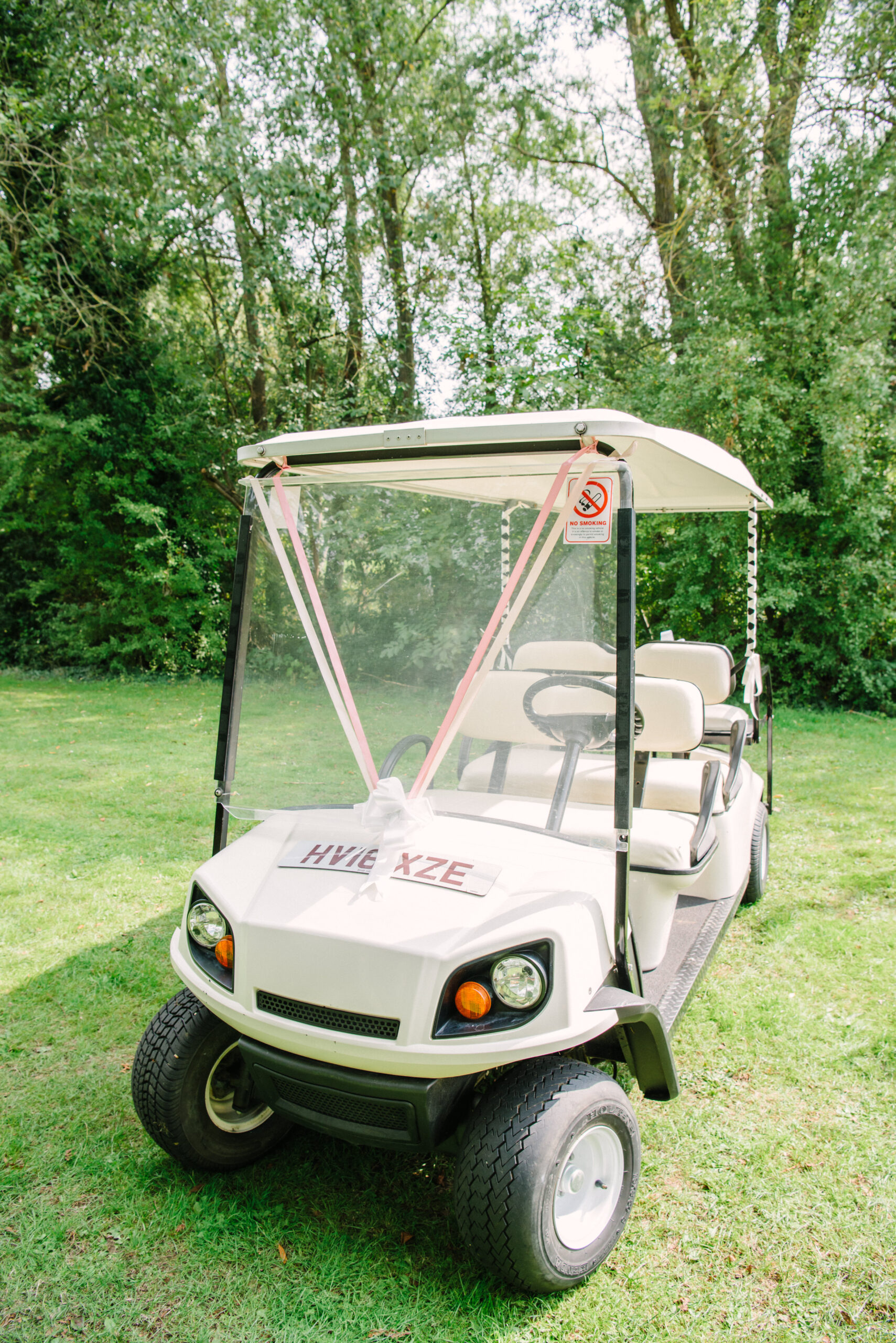 White wedding golf cart at Halliford Mere Lakes wedding venue