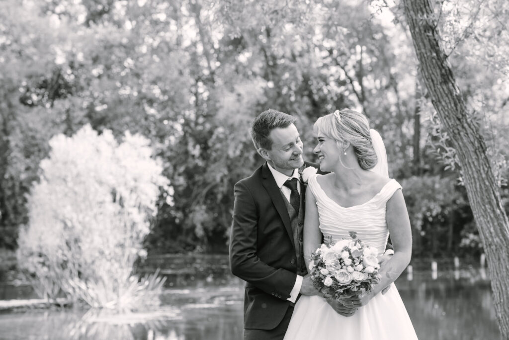 Happy wedding couple laughing together at Halliford Mere Lakes wedding venue