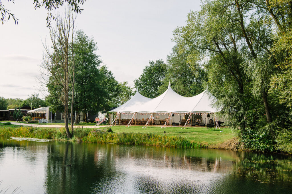 Outdoor marquee wedding next to a lake in Surrey