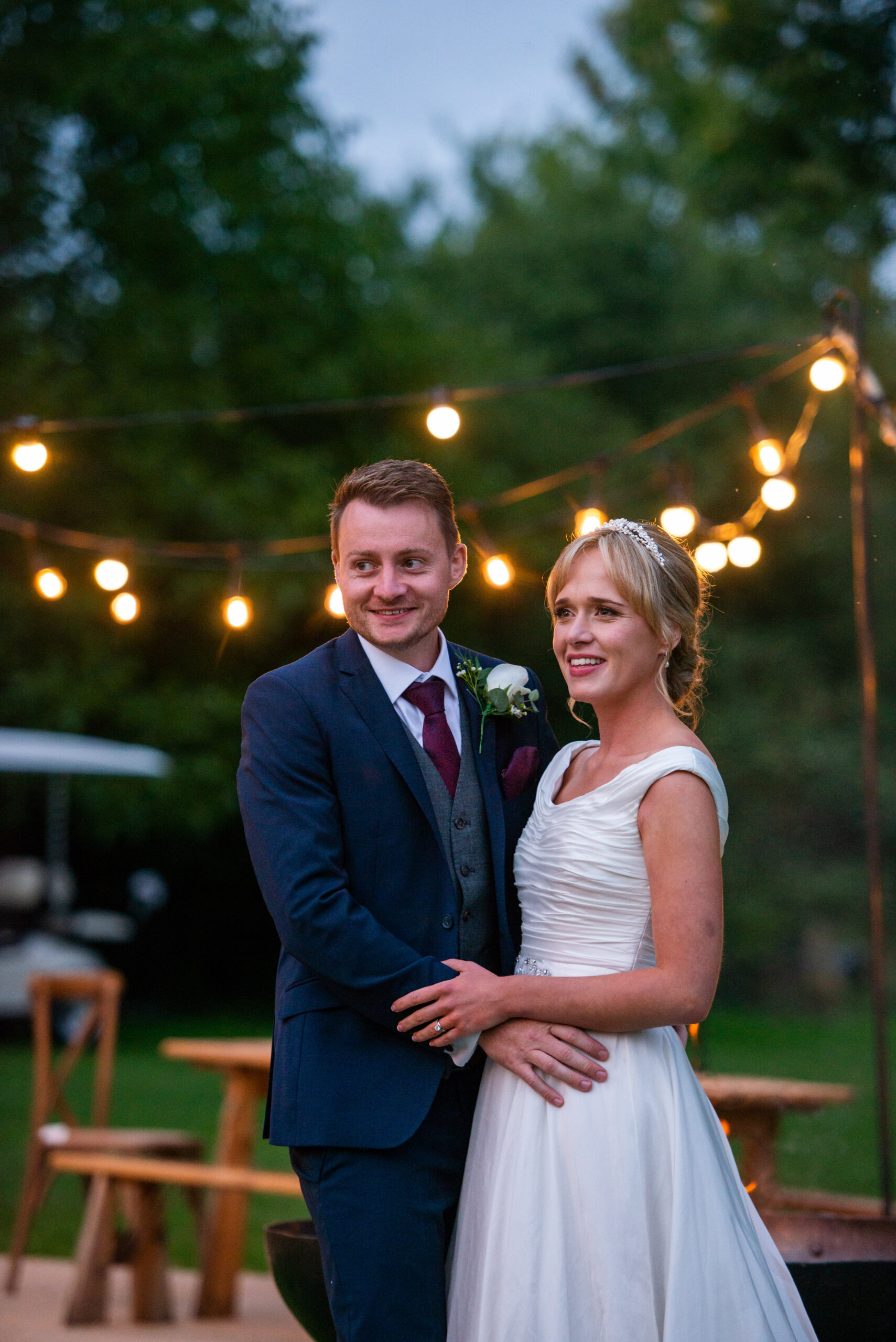 wedding couple in front of festoons during their surrey wedding