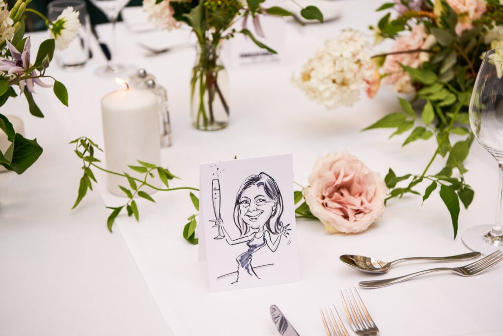 Caricature drawing of a wedding guest on the dinner table at Bluebird in Chelsea, London