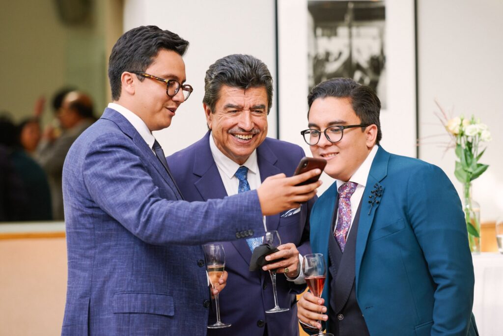groom laughing with his dad and brother at the Bluebird in Chelsea, London