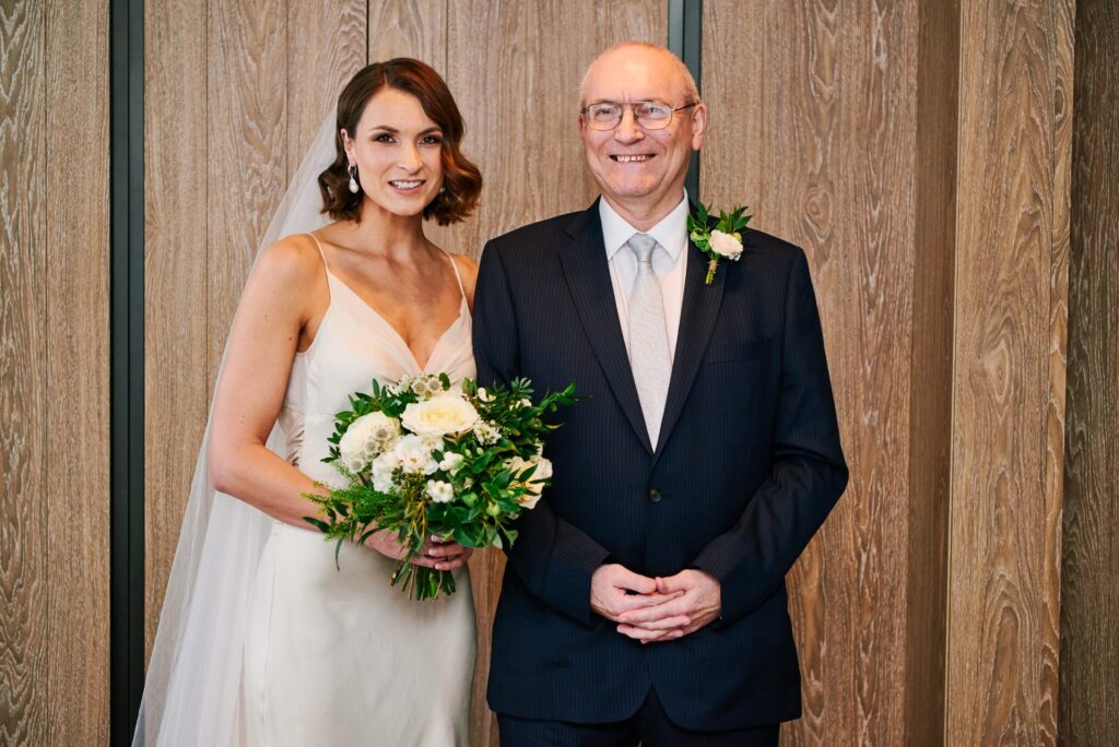 Bride stood with her dad in a London hotel room on her wedding day