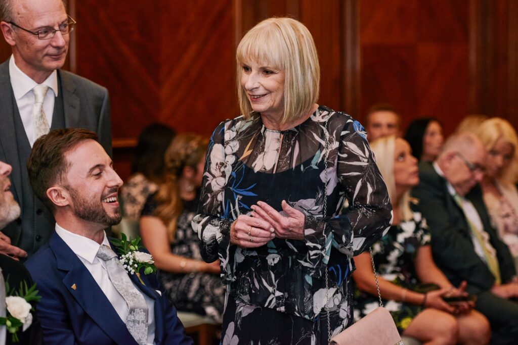 wedding guest smiling in the Westminster ceremony room at Old Marylebone Town Hall