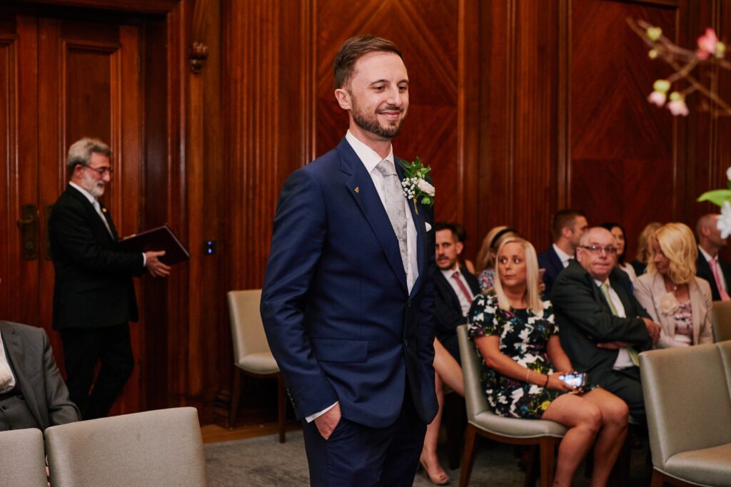 Groom stood waiting for the bride in the Westminster room at Old Marylebone Town Hall
