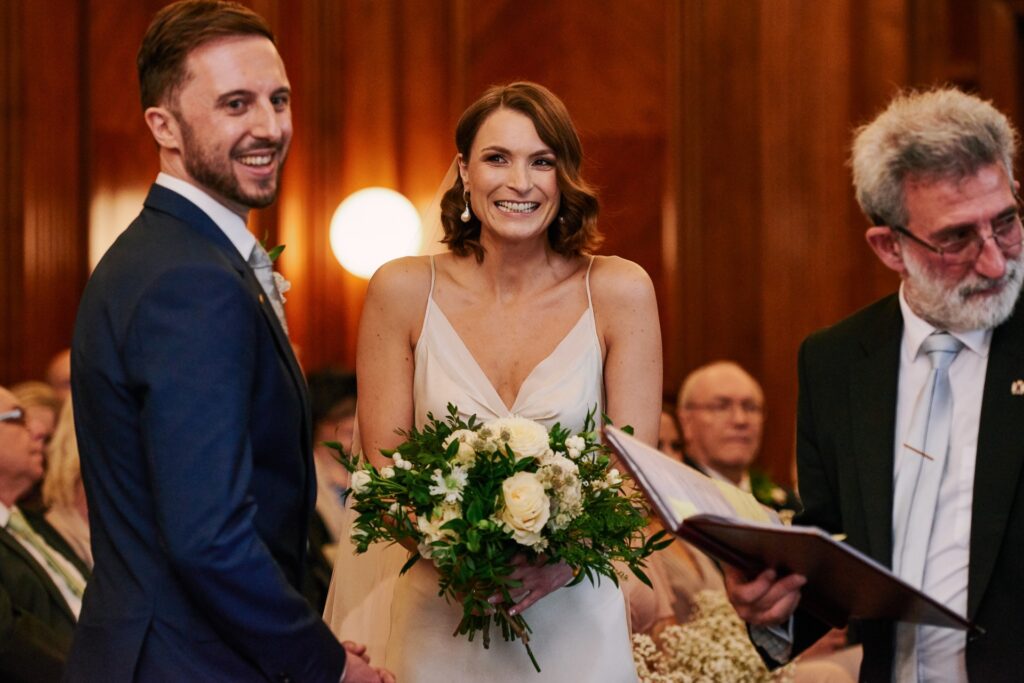 Bride & groom smiling during their small wedding ceremony at Old Marylebone Town Hall