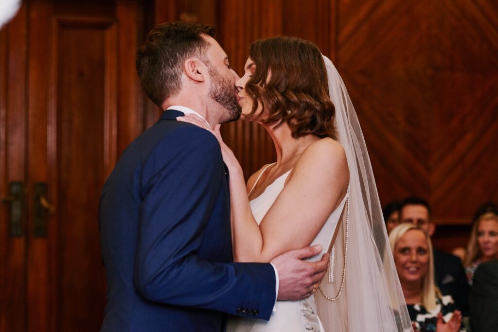 Bride & groom kissing during their intimate wedding at Old Marylebone Town Hall