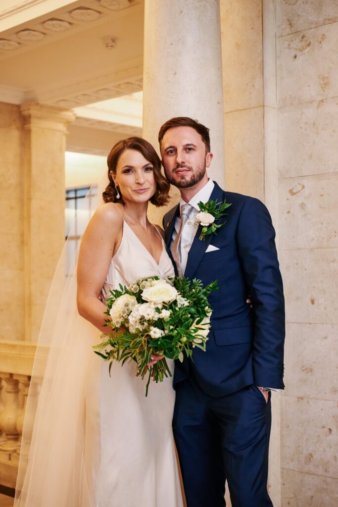 wedding couple stood in the marble hallway at The Old Marylebone Town Hall in London
