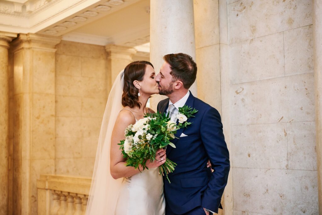 Bride & groom kissing in the marble hallway at Old Marylebone Town Hall