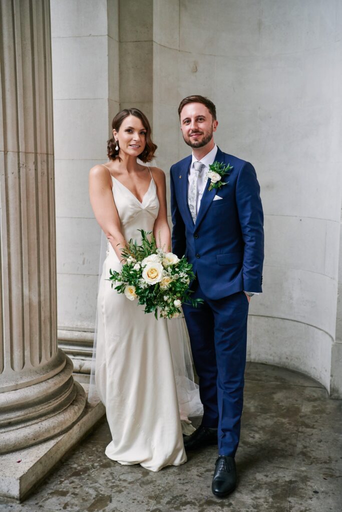 Bride & groom stood in front of The Old Marylebone Town Hall building